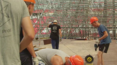 Builders work between assembled frame and swimming pool Stock Footage 234322809