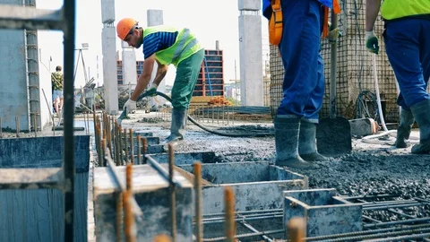 Builders work with concrete on construction site. Stock Footage