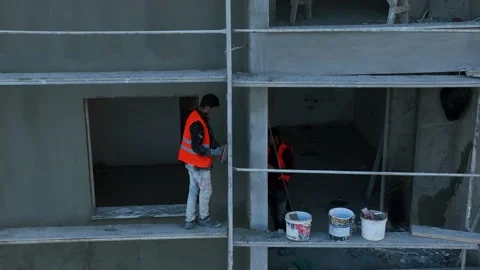 Builders work facing the building stand on the scaffolding Stock Footage 231465546