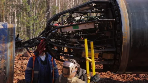 Builders work on the interior of a new gas pipe. Stock Footage 171878790