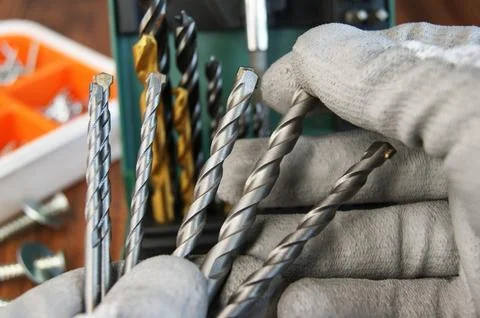 Builder's work process. Selection of drills before starting work. Stock Photos