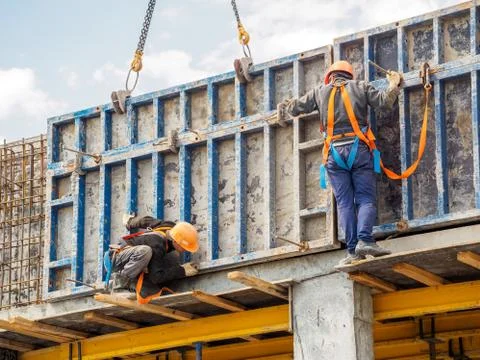 Builders work on skyscraper construction Stock Photos