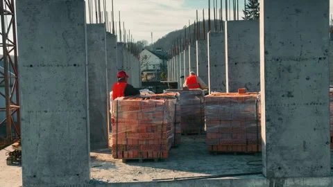 Builders working on construction and laying bricks. Bricklaying of a brick multi Stock Footage 252213230