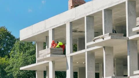 Builders working on the construction site. Workers fix plasterboard plates. Stock Footage 229561009