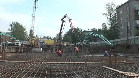 Builders working knead concrete at a construction site Stock Footage 5165082