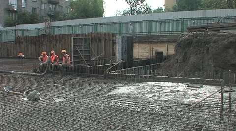 Builders working knead concrete at a construction site Stock Footage 5165087