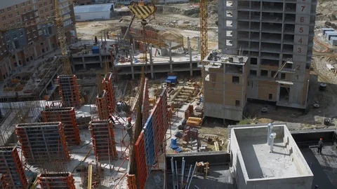 Builders working on rooftop of Unfinished Residential Building Construction Site Stock Footage 98701910