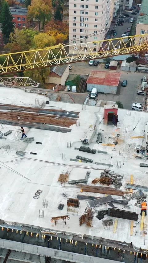 Builders working on top floor of multistory residential building under cons.. Stock Footage 337543047