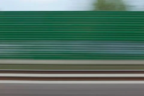 A building and abstract pattern in blurred motion viewed from moving train Stock Photos