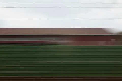 A building and abstract pattern in blurred motion viewed from moving train Foto stock
