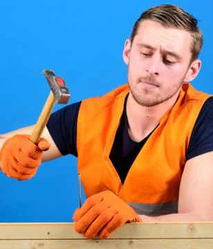 Building and construction concept. Carpenter, woodworker on busy face hammering Fotos de archivo