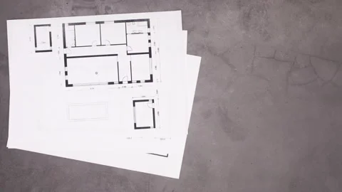 Building and construction tools with plans appear on work table. Stop motion Stock Footage 136917473