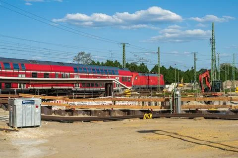 Building and driving , a DB train passes through a construction site Stock Photos