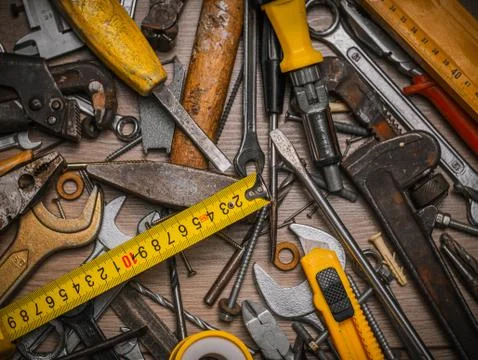 Building and measuring tools. Set of tools over a wood panel. Construction To Stock Photos
