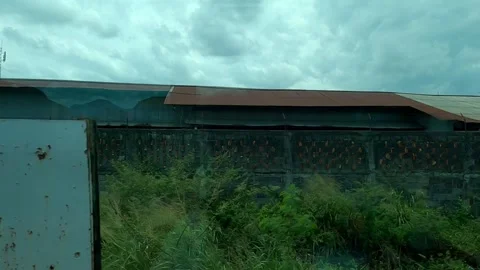 Building and trees  with high speed of train Panoramic Train Inside View pas Stock Footage 305332079