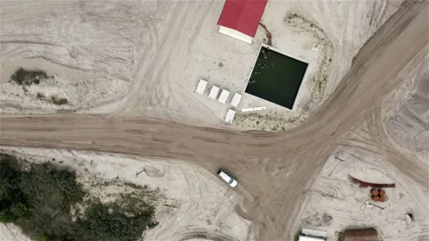 Building and underground structure with water at the carriageway of the road Stock Footage 117727051