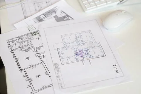 Building architectural drawing, white computer mouse on table. workplace Fotos de archivo
