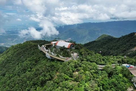 A building atop a mountain, enveloped by trees and nature Vietnam Da Nang Ba Na Stock Photos