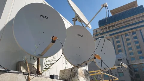 Building with attached satellite dishes for receiving TV or radio signal Stock Footage 128920788