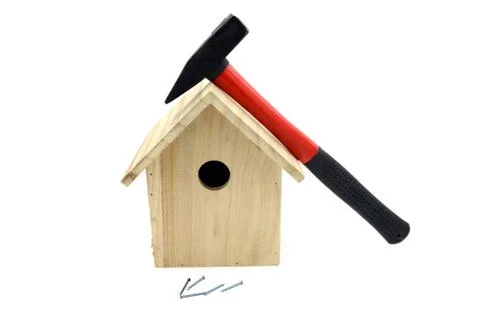 Building bird nesting box with hammer, nails Stock Photos