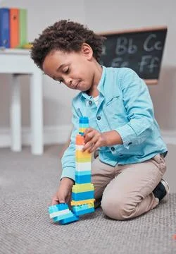 Building blocks, boy and playing in preschool, education and learning on floor Fotos de archivo