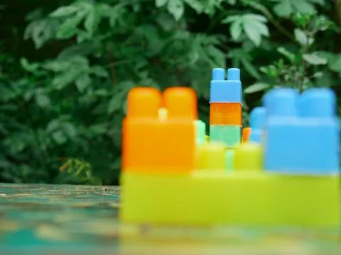 Building blocks closeup between view around natural green blur leaves backgro 스톡 사진
