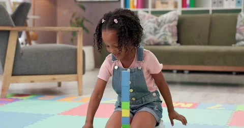 Building blocks, playing and kid on floor in home for cognitive development or Stock Footage 308437751
