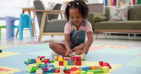 Building blocks, playing and kid on floor in house for cognitive development or Stock Footage 308438282
