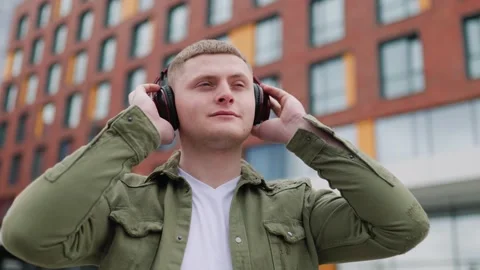 Building Bops Handsome Guy Relaxing with Headphones On Stock Footage 244083378