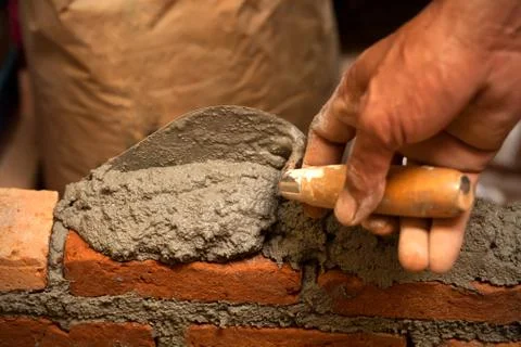 Building brick wall with mortar Stock Photos