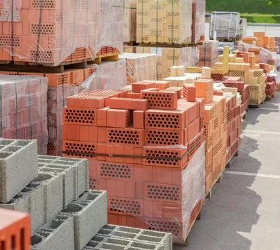 Building bricks and other construction materials on an outdoor warehouse Foto stock