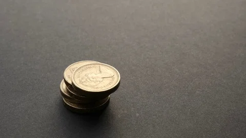 Building British One Pound Sterling coin stack 4K UHD Stock Footage