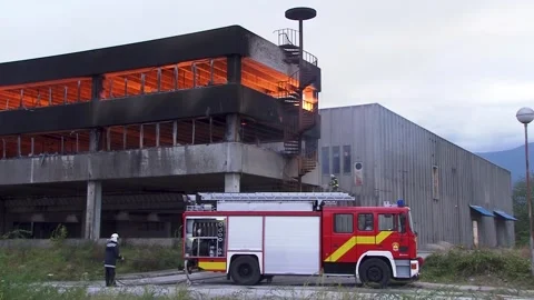 Building caught in a big fire, firefighters Stock Footage 288331326