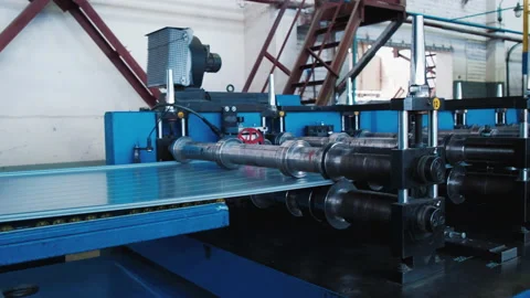 Building Cladding Material. Heavy Rollers Give Shape to Sheet Metal. Production Stock Footage 211921981