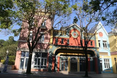 A building with a clock on the front has a red roof Stock-Fotos