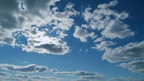Building clouds and sun rays breaking through cloud mass. Flares shinning Stock Photos