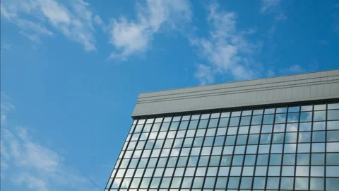 Building with clouds on blue sky Stock Footage 142891726