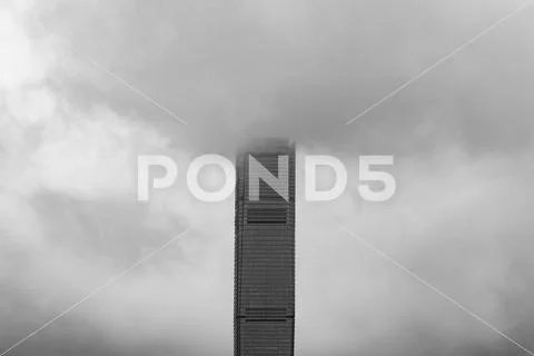 Building with clouds in storm. Dramatic sky with raining. Windows glass of mo Stock Photos