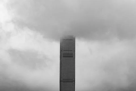 Building with clouds in storm. Dramatic sky with raining. Windows glass of mo Stock Photos