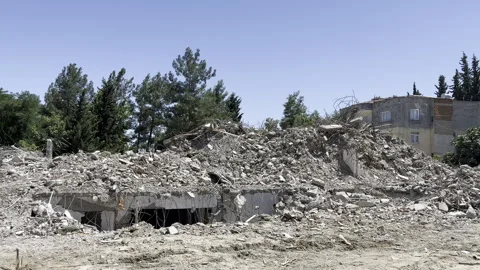 A building collapsed in the earthquake and its surrounding debris. Stock Footage 246142923