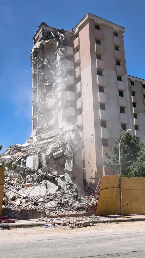 Building collapses during demolition in city at midday with dust and debris.. Stock Footage 337956370