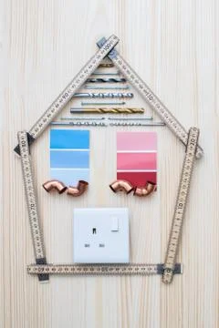 Building Components Arranged In Shape Of House On Wooden Background Stock Photos