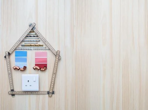 Building Components Arranged In Shape Of House On Wooden Background Foto stock