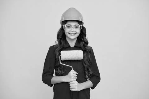 Building, construction and profession concept - smiling little girl in Stock Photos