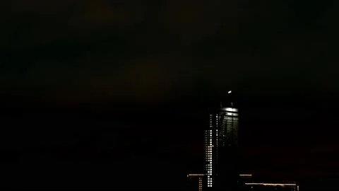 BUILDING CONSTRUCTION AT NIGHT. Isolated. With a working crane on the roof of a Stock Footage 208025516