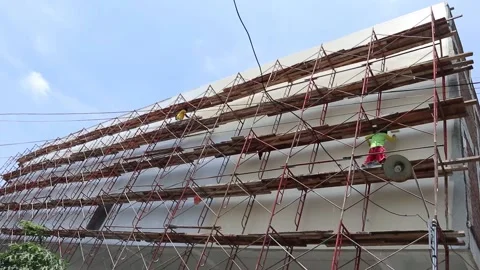 Building construction process. Scaffolding. Stock Footage 164884822