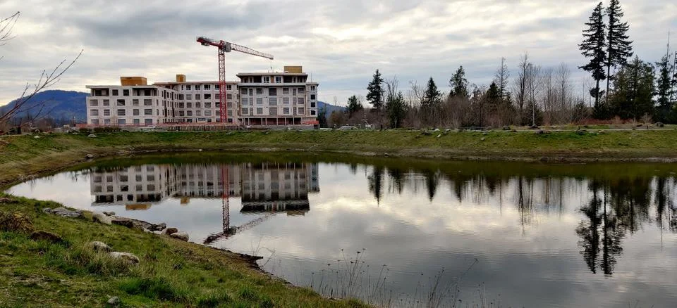 Building construction reflected in a lake Stock Photos
