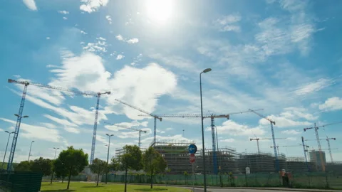 Building construction site with cranes, clouds and blue sky. Time lapse. Stock Footage 154158512