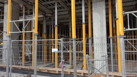 Building construction site ground level viewed through metal fence, barricade Stock-Footage 99425953