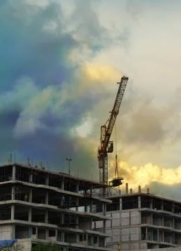 Building construction site under evening sky Stock Photos